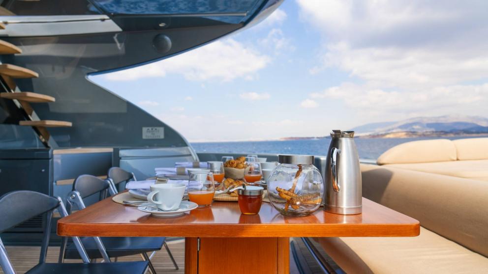Aft deck dining table on the luxury motor yacht Whatever