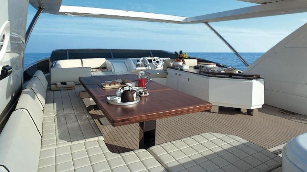 Dining and seating area on the flybridge of luxury motor yacht La Fenice