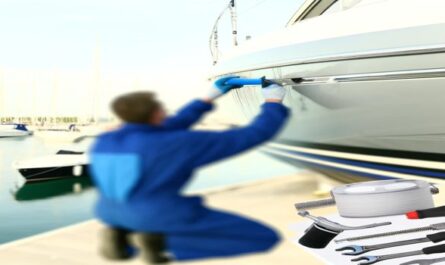 A detailed view of yacht maintenance in a marina, featuring a professional working on the hull with necessary tools, surrounded by docked boats under a sunny sky