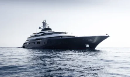 A luxury mega yacht anchored on calm open sea under soft daylight