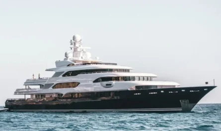 A sleek luxury yacht anchored calmly on open blue sea under a clear bright sky
