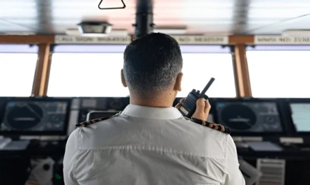 A captain manages navigation systems onboard a luxury yacht rental