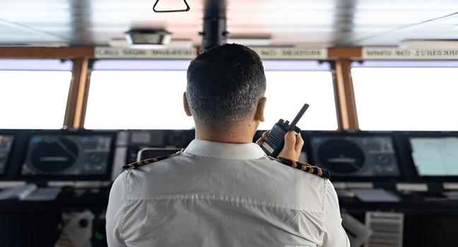 A captain manages navigation systems onboard a luxury yacht rental
