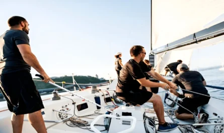 A sailing crew working in sync on a modern charter yacht