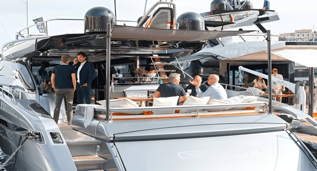 Businessmen networking on a luxury yacht deck during a yacht show