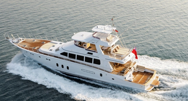 Elegant superyacht cruising through calm waters at golden hour