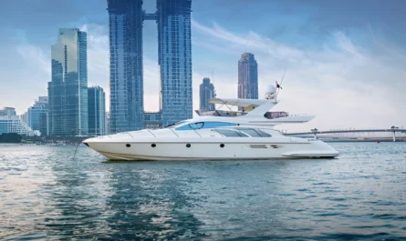 A sleek white luxury yacht anchored calmly with Dubai’s modern skyline behind