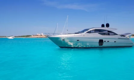 A luxury motor yacht floating in crystal-clear turquoise sea