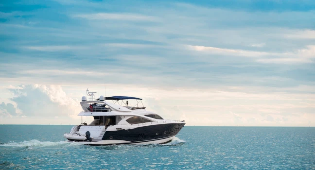 Motor Yacht Cruising in Open Waters Sleek motor yacht cruising freely in open blue sea under a bright sky Yacht Charter Croazia