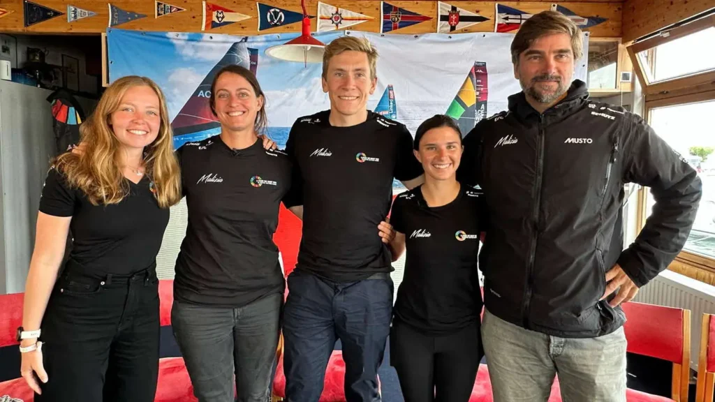 Die Crew von Team Malizia mit Boris Herrmann in Kiel, gemeinsam vor einer Regatta-Vorbereitung im Yachtclub.