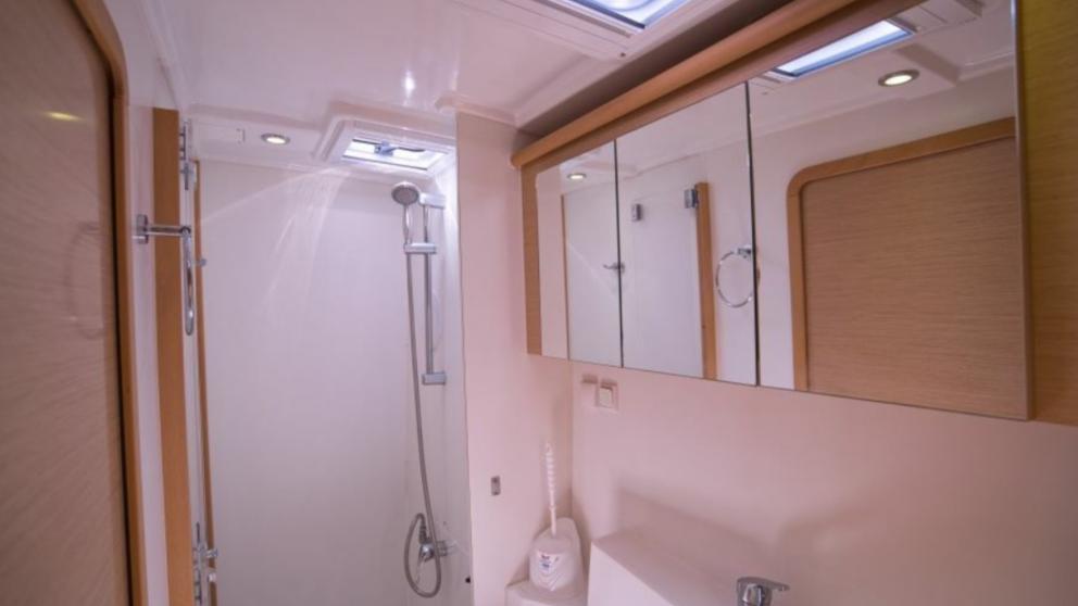 Bright bathroom of the catamaran. You can see the shower and mirror