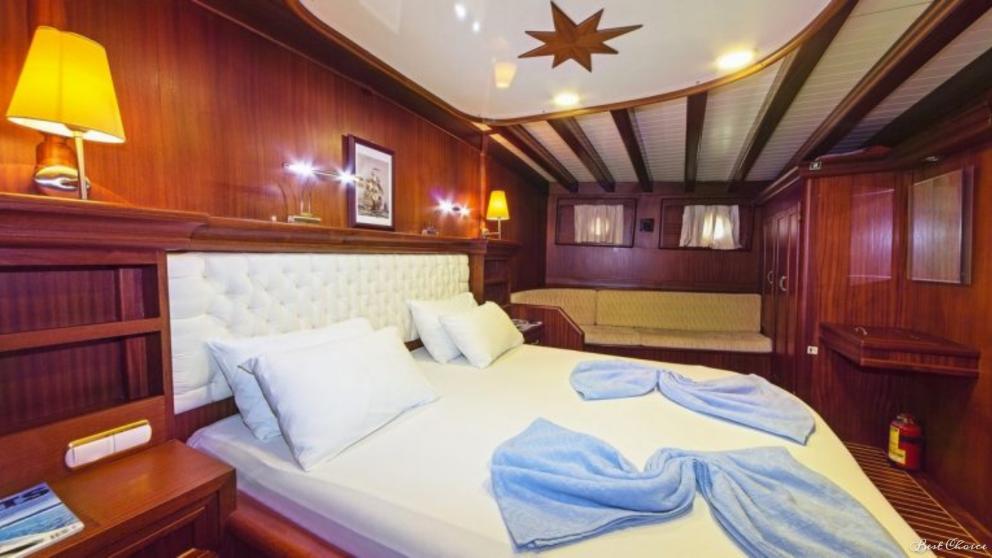 King size bed and storage areas in the spacious stateroom on the A Candan gulet