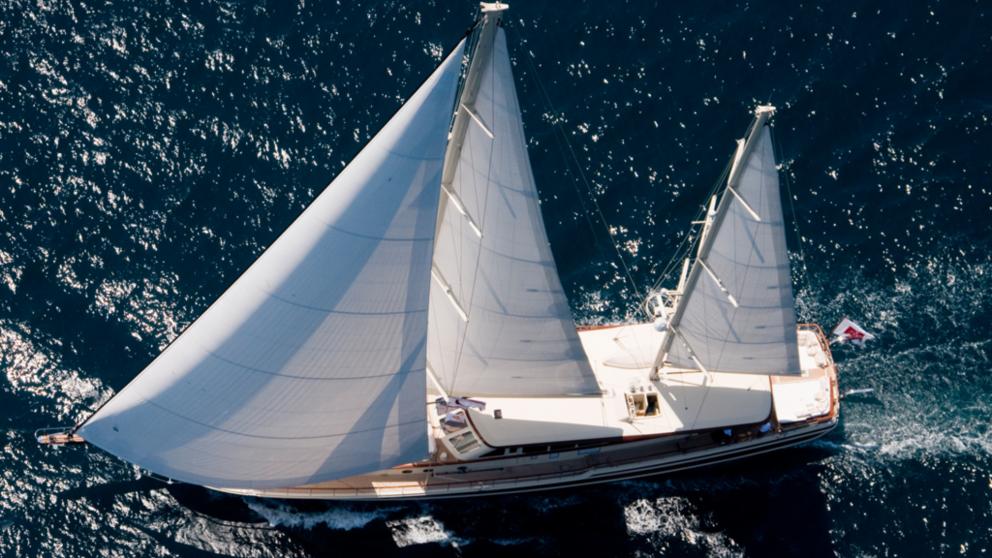 A bird's-eye view of the Daima gulet and its white sails.