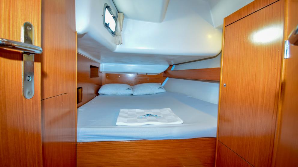 Double bed and wardrobes for storing personal belongings in the cabin