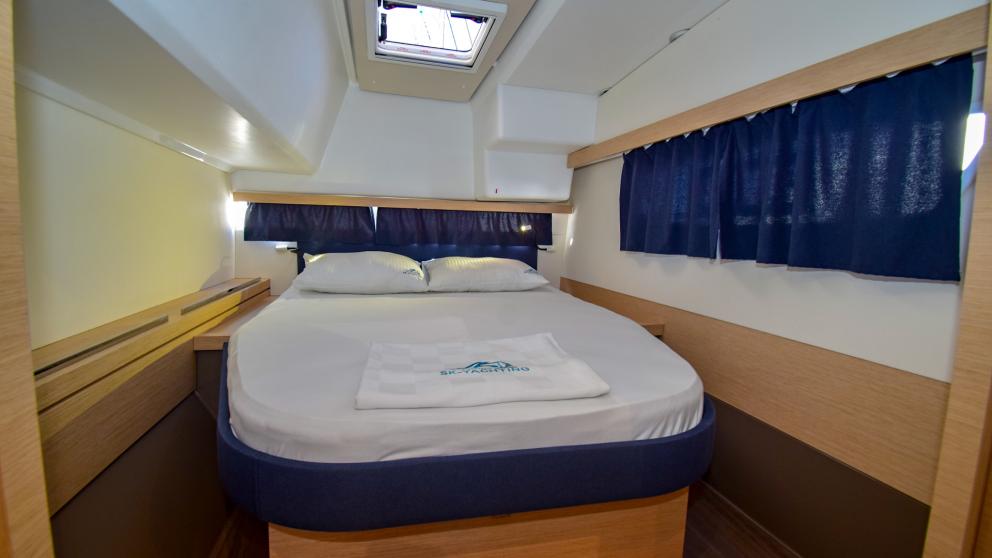 Ceiling porthole and large windows in the bright cabin of the catamaran Coco D