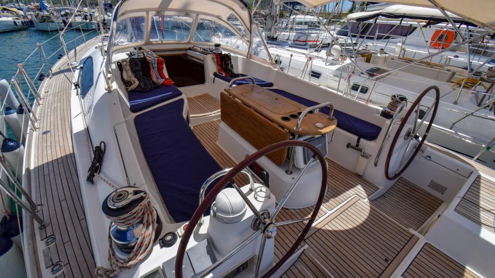 Cockpit of sailing yacht eleven with blue sofas and table