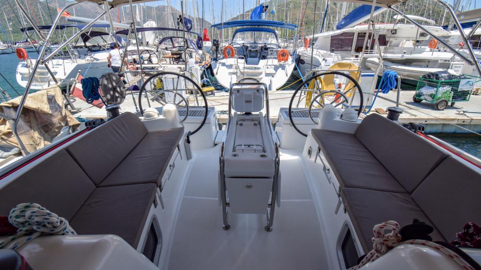 Cockpit with soft gray sofas and double steering wheel on sailing yacht Сode