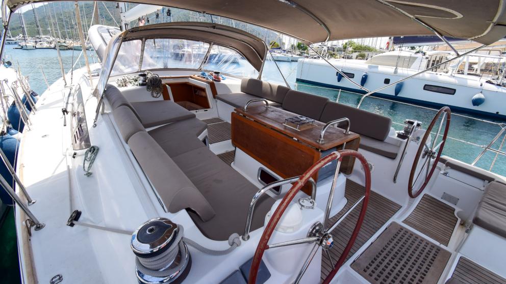 Cockpit with soft gray sofas and double steering wheel on sailing yacht Anja Sophie
