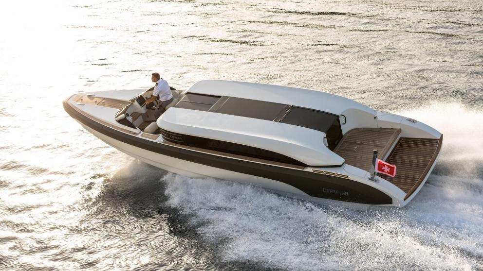 Sleek speedboat Opari, cruising on the water with a driver and flag.