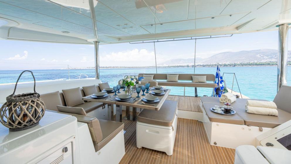 Dining table and seating area on the aft deck of the luxury catamaran Royal Flush picture 2