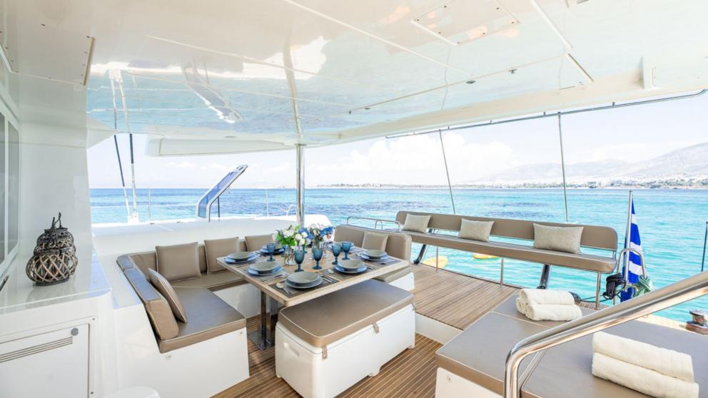Dining table and seating area on the aft deck of the luxury catamaran Royal Flush picture 3
