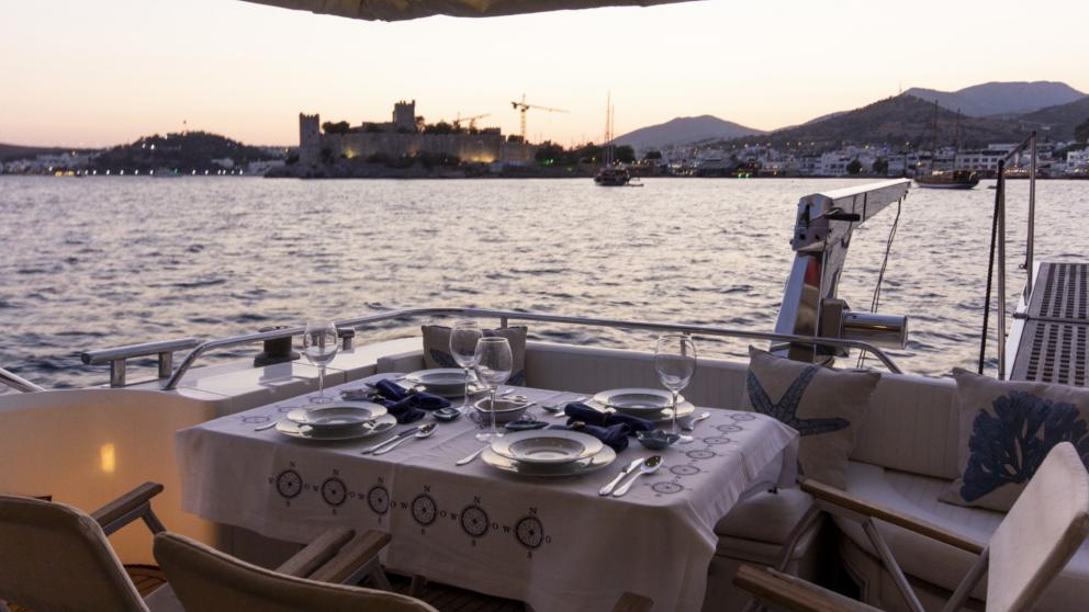 Served dinner table at the stern of motor yacht Newdawn