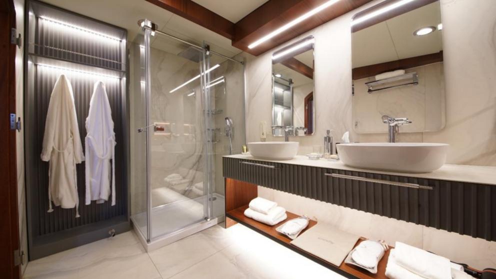 Bathroom on the Mare Nostrum gulet with shower, two sinks and white dressing gowns