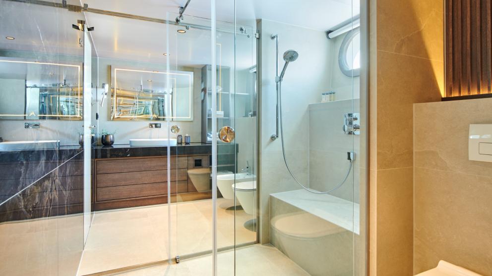 Modern bathroom of Anima Maris with large shower, vanity, and toilet.