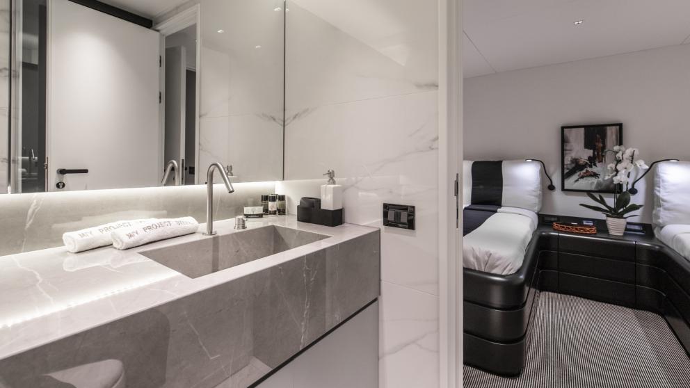 Modern bathroom adjacent to the comfortable twin bed cabin on the luxurious yacht Project Steel.