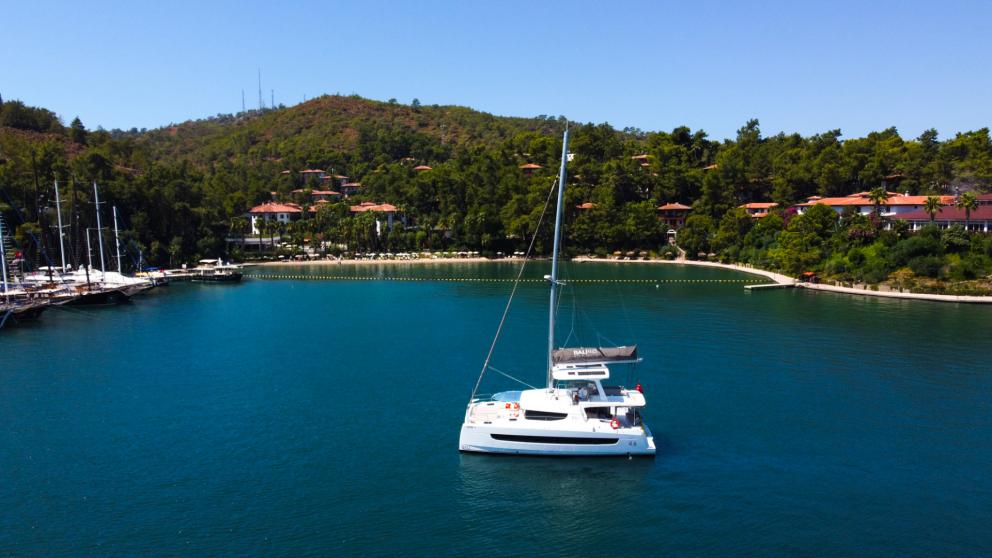 Anchored in a quiet bay, the catamaran stands in the sea with all its beauty.