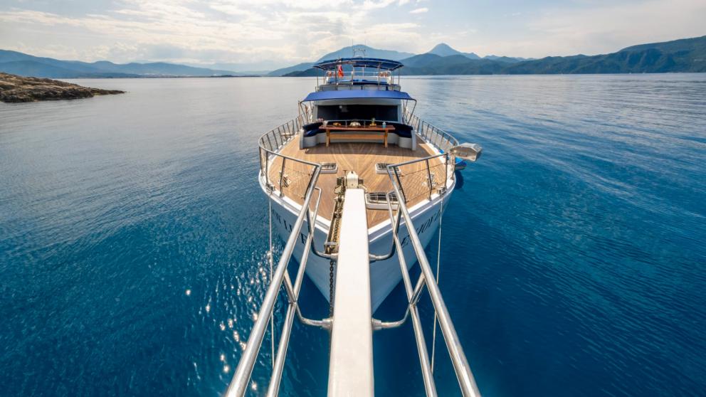 The gulet Enjoy Life glides majestically over the calm, deep blue waters of Fethiye.