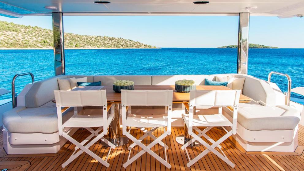 Dining area with panoramic views on the 27-meter motor yacht Dawo in Sibenik, perfect for outdoor meals.