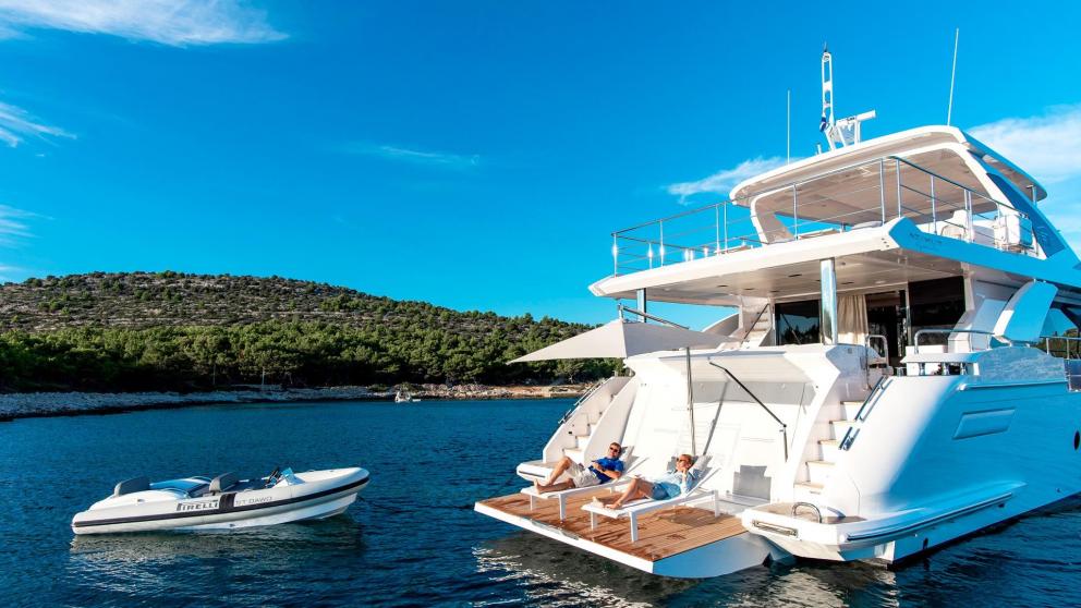 Guests relaxing on the aft deck of the 27-meter motor yacht Dawo in Sibenik.