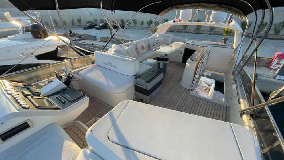 The flybridge deck of the luxury motor yacht Melissa My Angel in Göcek offers spacious seating areas and control panels.