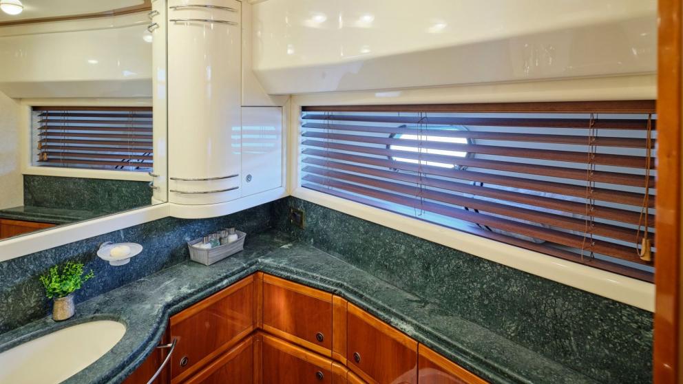 Elegant bathroom on a yacht with green marble countertop and modern amenities