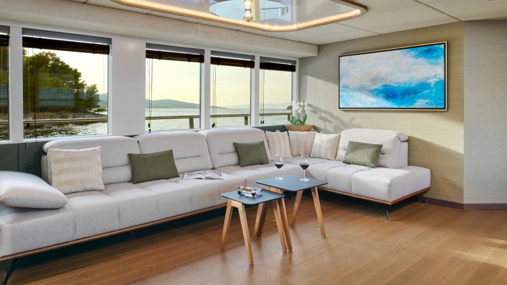 Stylish lounge with large windows and sea view aboard Anima Maris, perfect for relaxing.