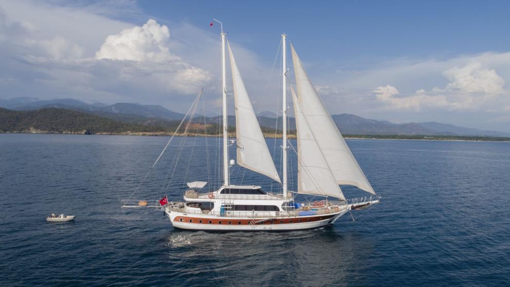 Traditional Turkish sailing boat with five cabins, in the blue sea of Fethiye.