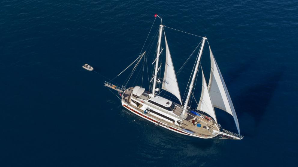 Traditional Turkish sailing boat with five cabins in the blue sea of Fethiye.