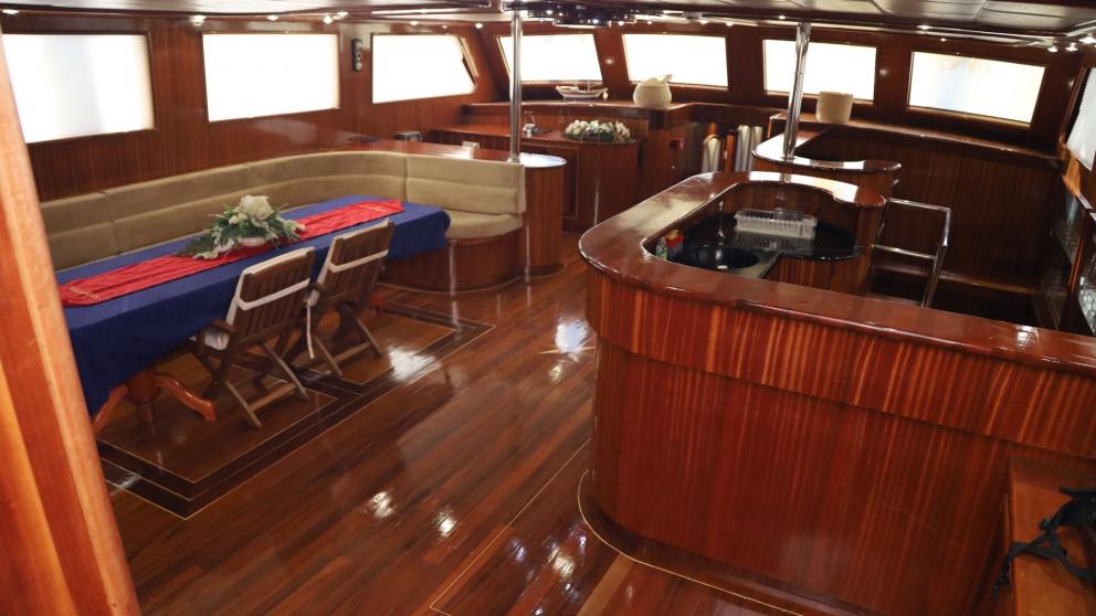 Luxurious interior of a yacht with dining area and bar.