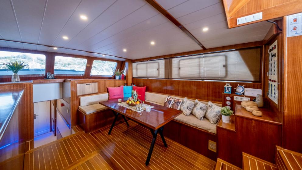 Cosy and elegant saloon area on the gulet Enjoy Life with stylish furnishings and maritime accents.