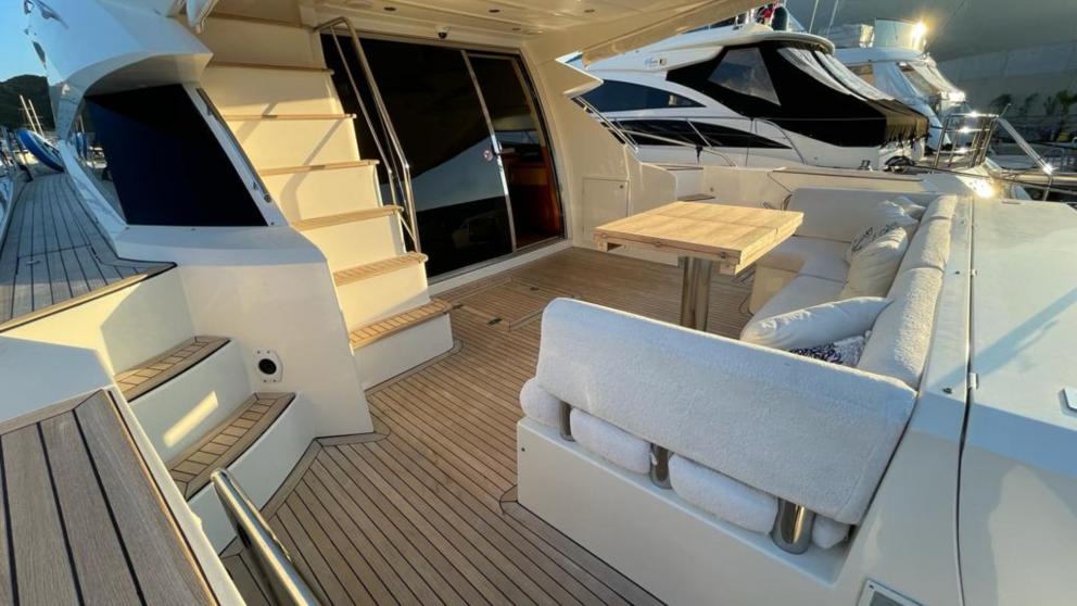 The spacious aft deck of the luxury motor yacht Melissa My Angel in Göcek features a comfortable seating area and table.