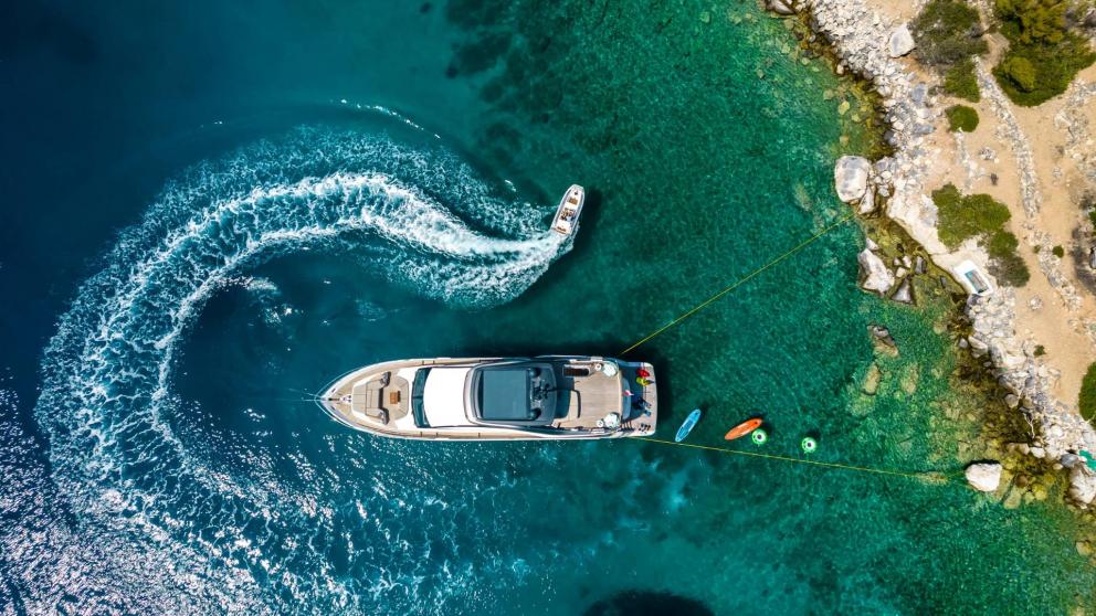 Admire the Vista motor yacht in the clear waters of Greece. Perfect for water sports enthusiasts!