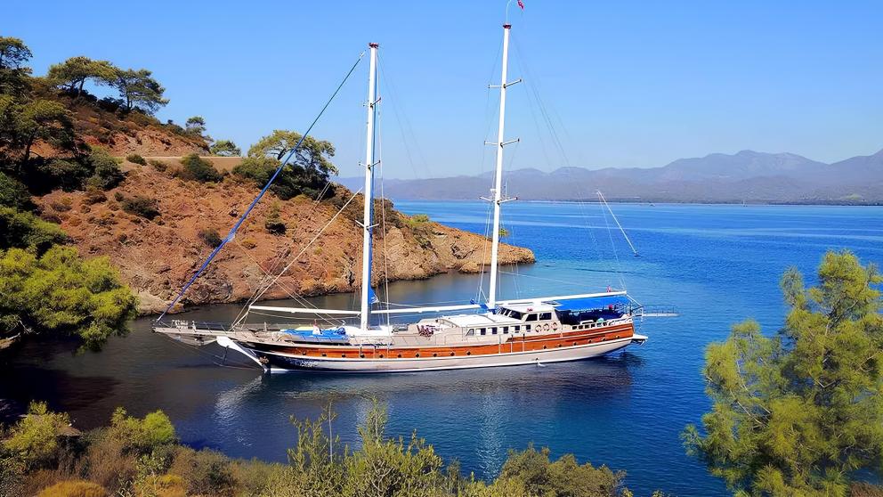 Gulet Prenses Selin is situated in a picturesque bay with wooded hills and clear blue water.