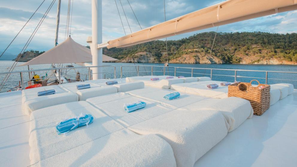 Sun deck with comfortable loungers on the Grand Acar Gulet in Fethiye.
