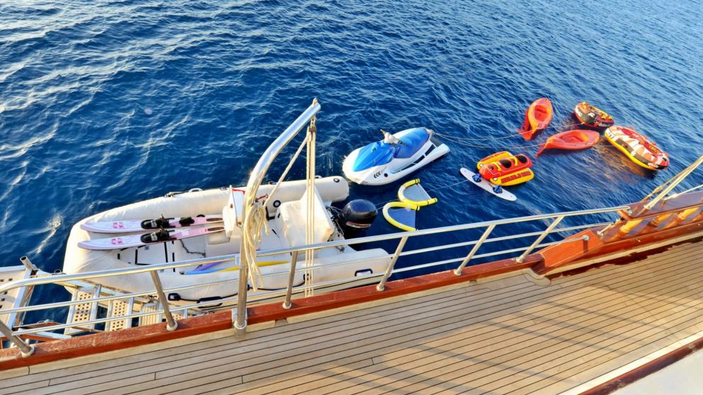 Various water sports equipment next to the sailing boat Gulet Berrak Su.