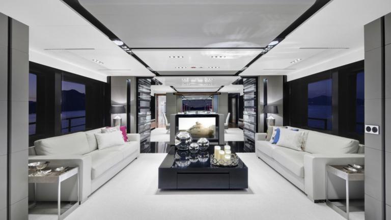 Luxury motor yacht saloon designed with harmony of white, gray and black colors.