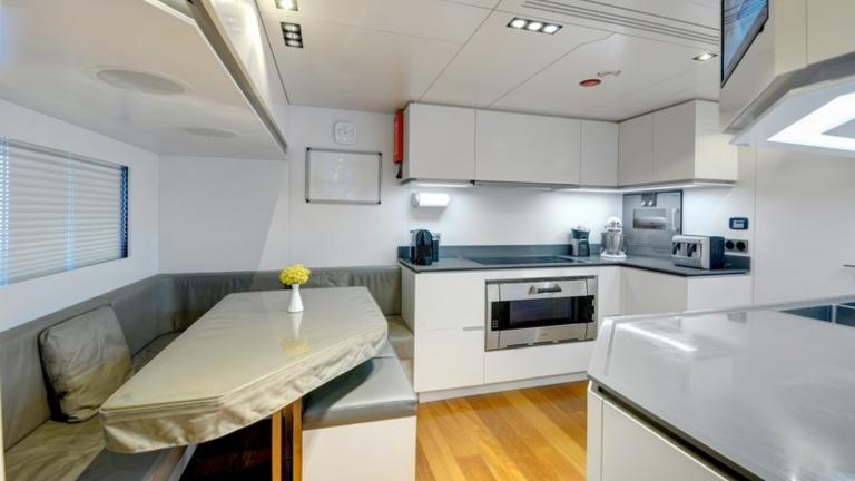 A modern yacht kitchen designed with white tones.