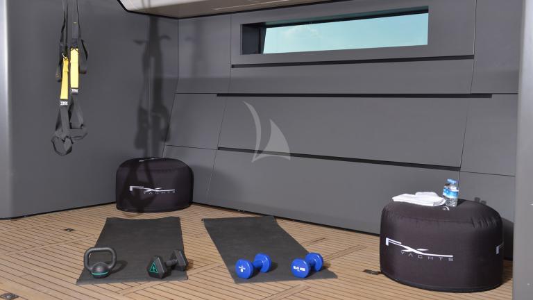 Gym and some sports equipment inside the motor yacht.