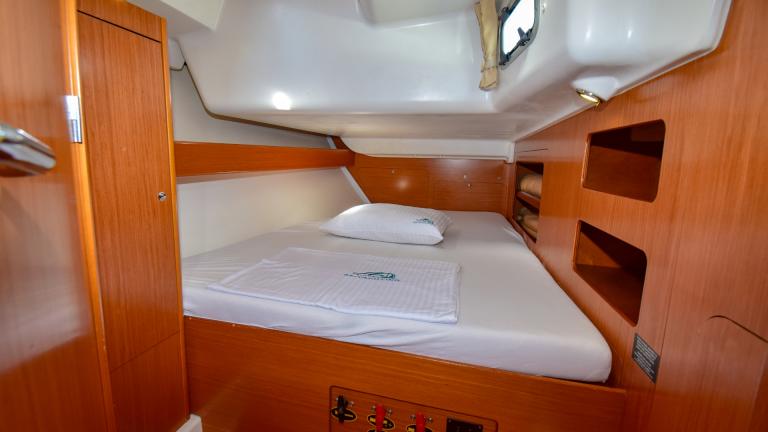 Storage areas for personal belongings and a double bed in the cabin