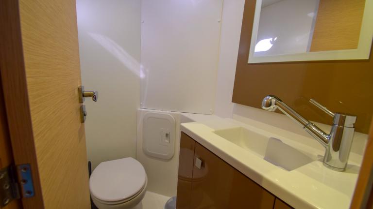 Plumbing on a catamaran. You can see a toilet and a sink with a faucet